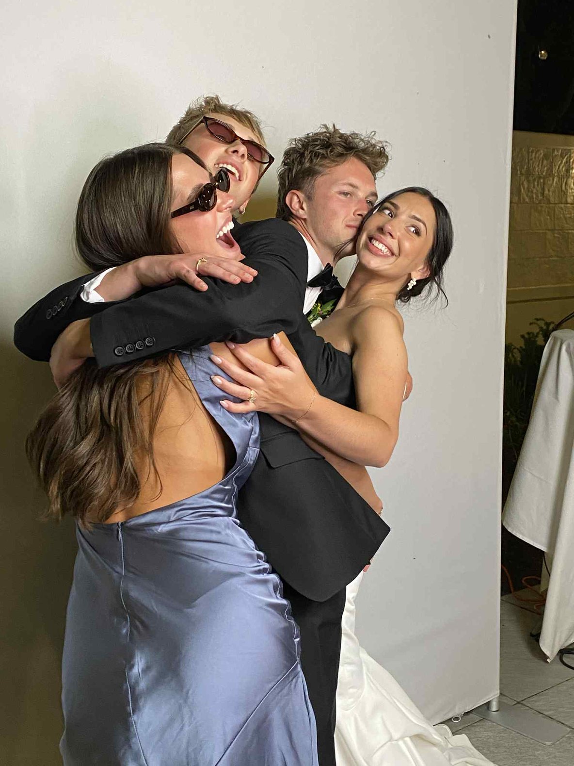Guests lifting each other up in front of the backdrop at a reception