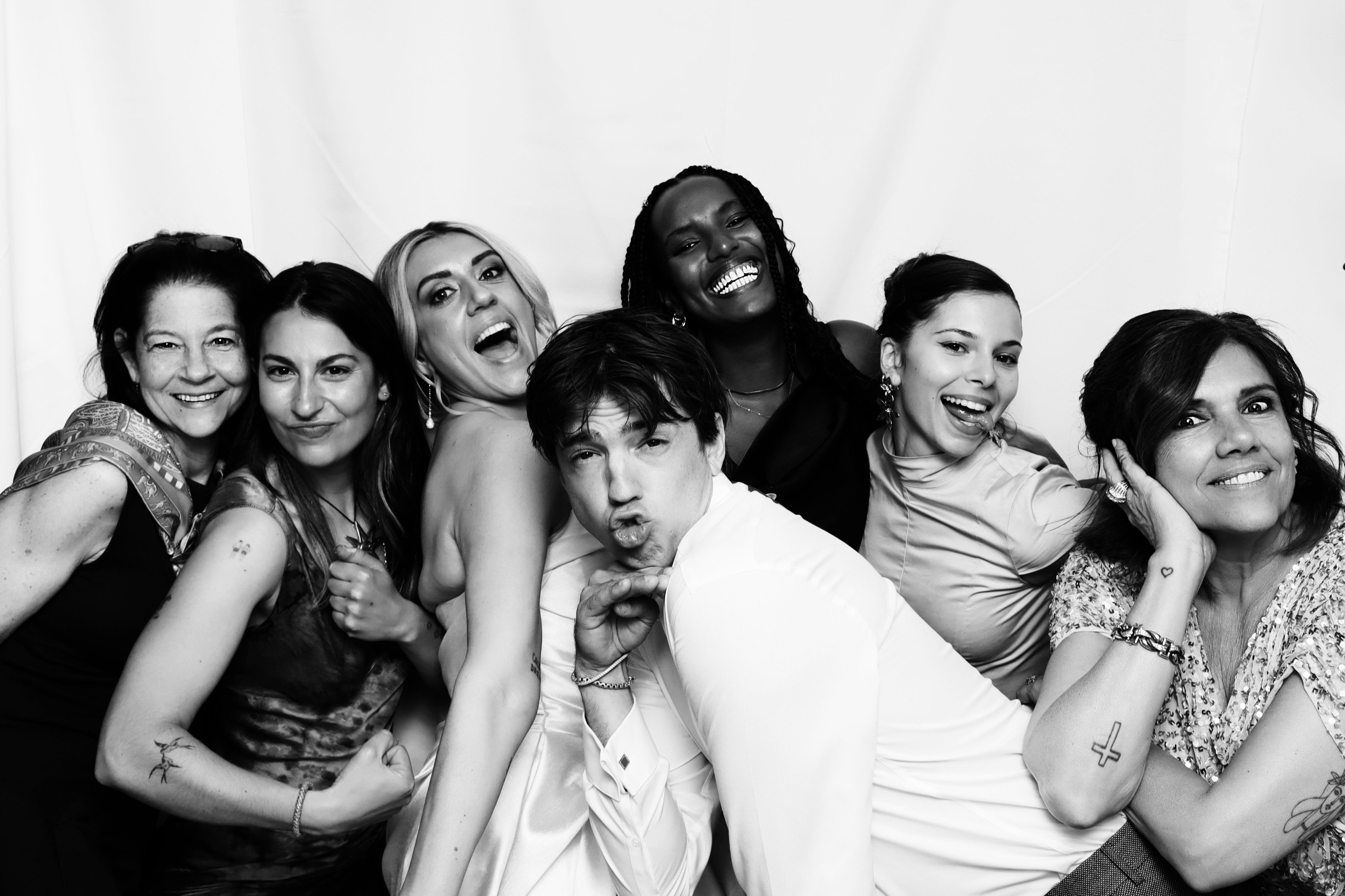 Friends laughing together in a black and white photo booth session