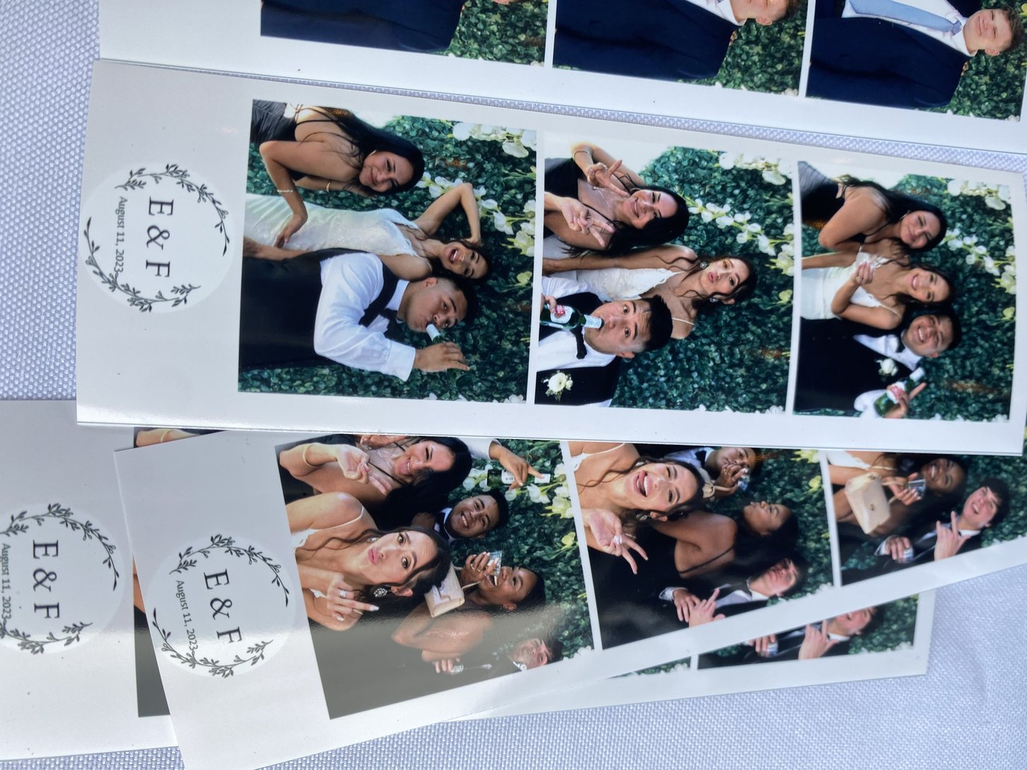Printed photo strips laid out on a table at an event