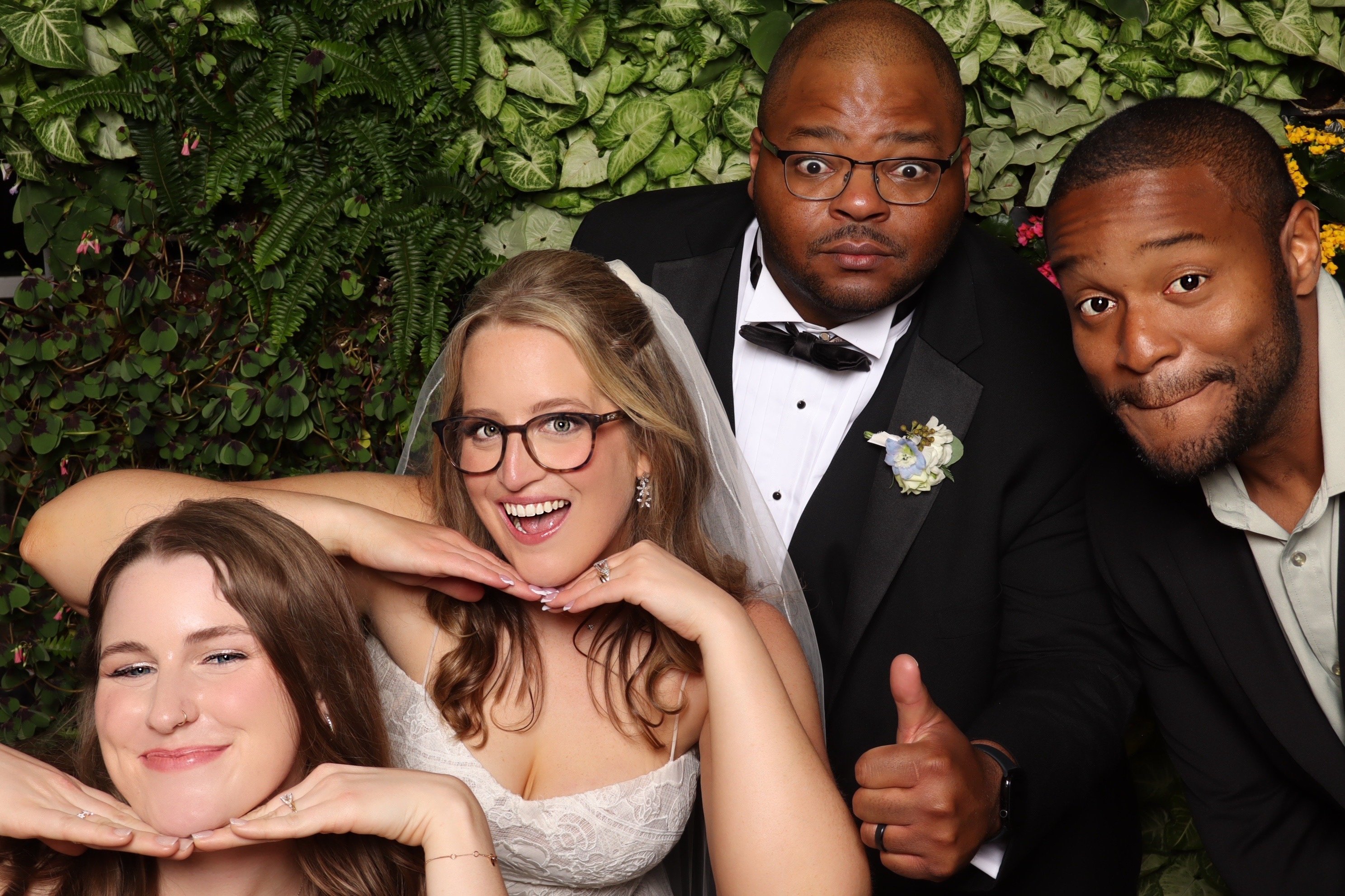 A couple and their wedding party crowded into one frame